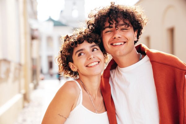 young-smiling-beautiful-woman-her-handsome-boyfriend-man-posing-outdoors-cheerful-couple